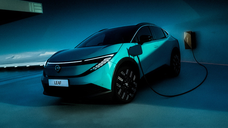 Nissan Leaf in Teal Blue plugged into a charging station.