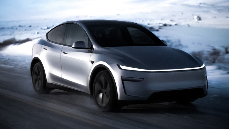 Tesla Model Y driving on a a snow-covered landscape on a road