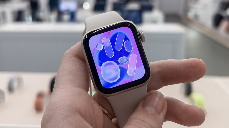 A person holding the Apple Watch SE 3.