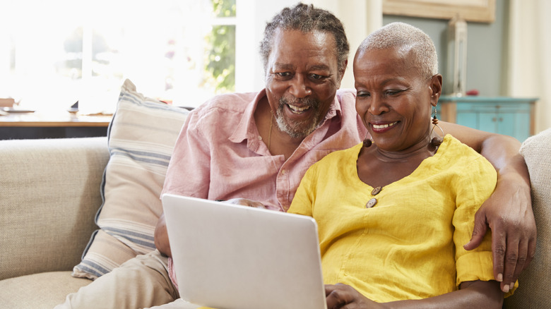 A senior couple using a laptop together