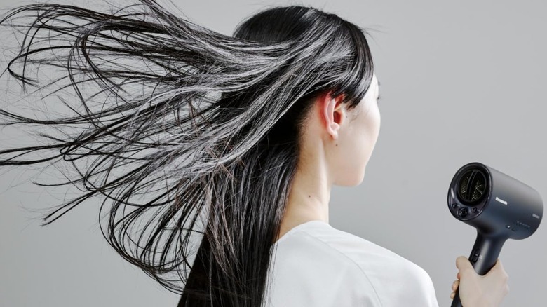 Woman using Panasonic Nanocare hair dryer
