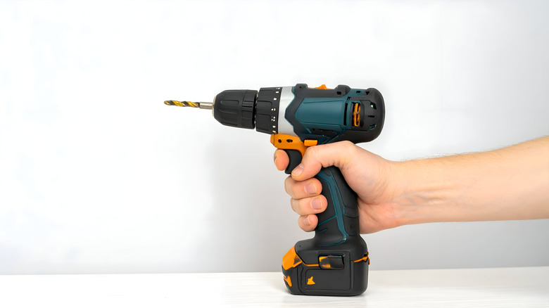 a hand holding a cordless drill ready for use