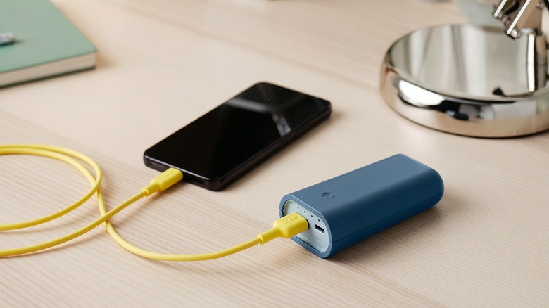 Varmfront Portable Charger charging phone on table