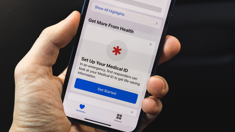 An iPhone in hand showing the Medical ID screen.