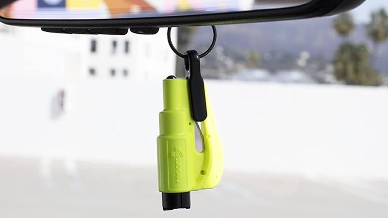 The Resqme Seatbelt Cutter and Window Breaker hung from a rear-view mirror.