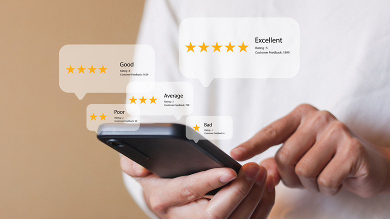 Person using a smartphone with review concepts appended on top