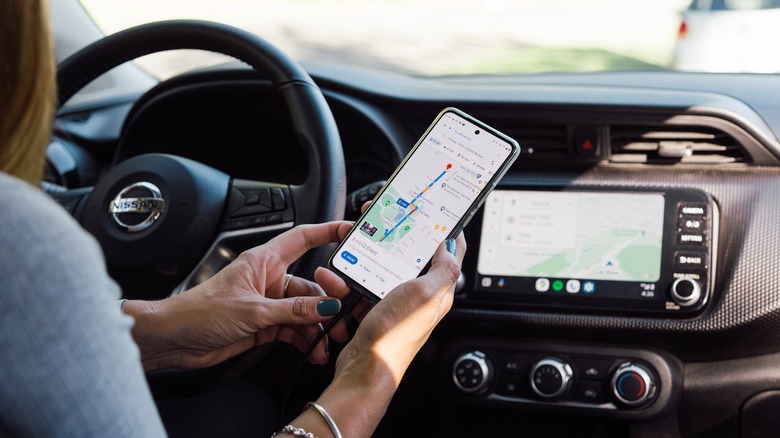 Looking at Google Maps on a phone and vehicle display