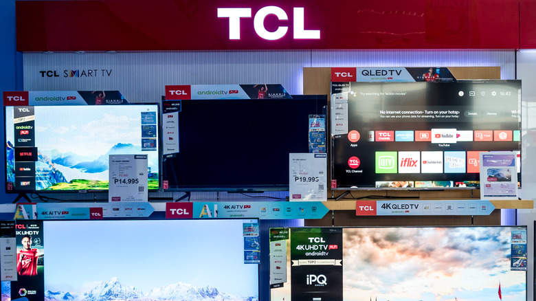 A lineup of TCL TVs on a showroom floor