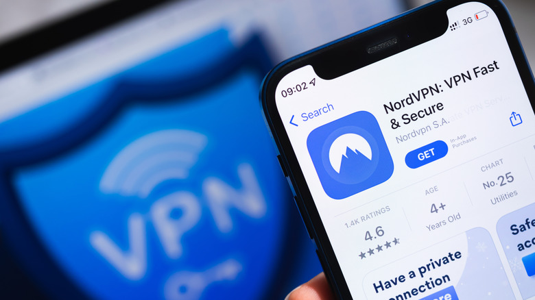 Person holding phone with screen showing NordVPN app