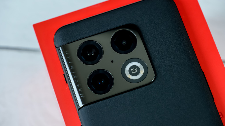 A close-up of a OnePlus phone on a red box