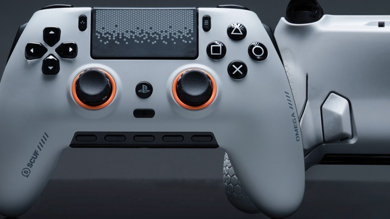 White Scuf Omega controller for PlayStation 5 front and back in front of black background