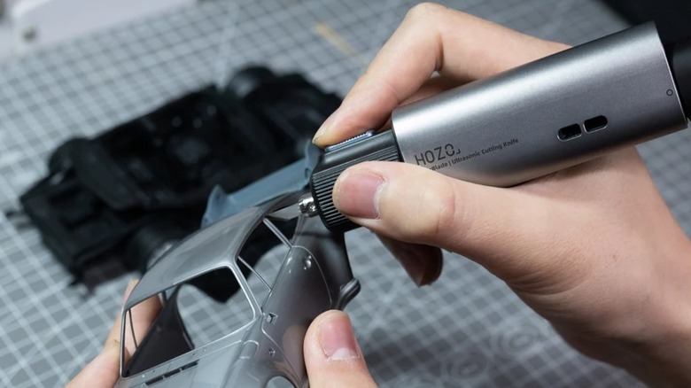 Hozo NeoBlade used to cut pieces of a model car.