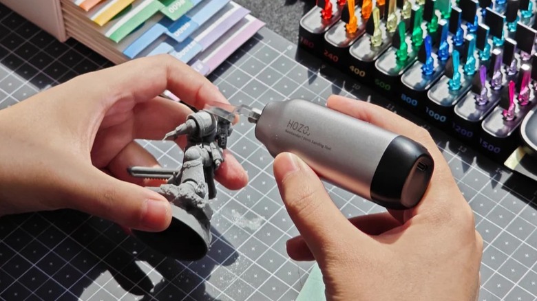 Hozo NeoSander used to polish surface of model figurine.