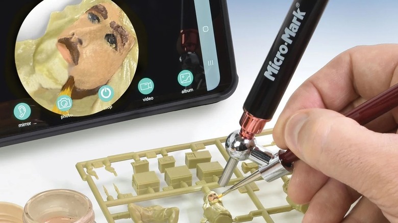 Micro-Mark BrushCam being used to paint a detailed face on a plastic model piece.