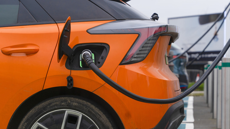 An electric car being charged at a charging station