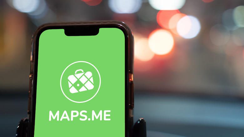 MAPS.ME logo and green background on an iPhone screen