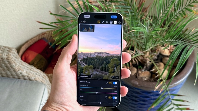 Hand holding Photomator app
