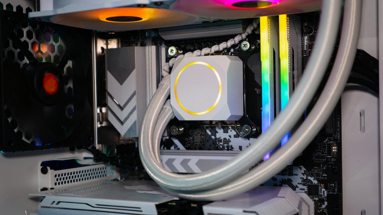 AIO liquid cooler installed inside a gaming PC with RGB fans and RAM.