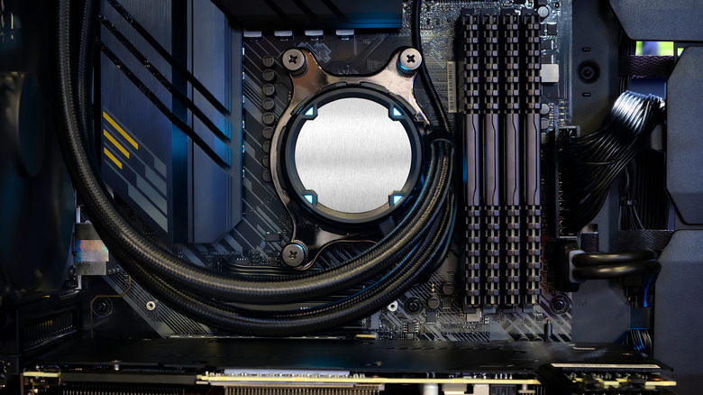 Close-up of a PC interior showing an AIO liquid cooler, motherboard, RAM sticks, and graphics card.