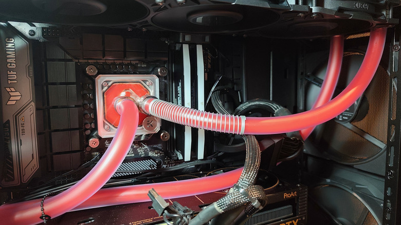 Custom liquid cooling loop inside a PC with red tubing connected to the CPU water block.
