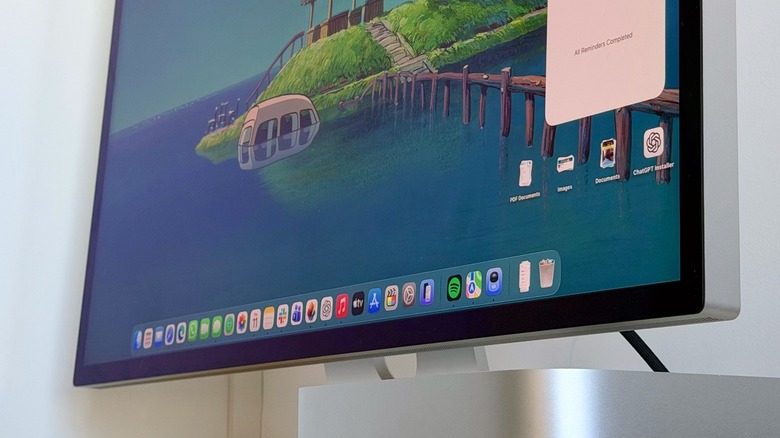Apple Studio Display with a few apps highlighted on macOS Tahoe Dock