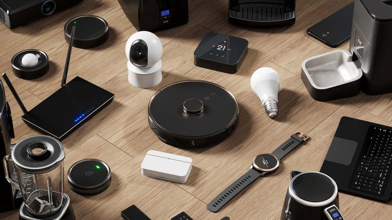 A collection of smart home gadgets kept on a wooden surface.