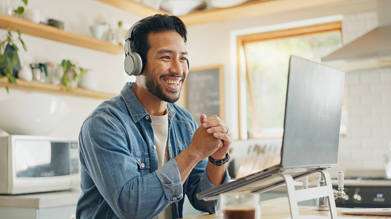 man working remotely with headphones on
