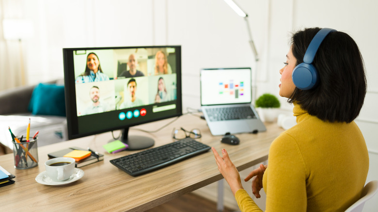 Woman on video call with six people