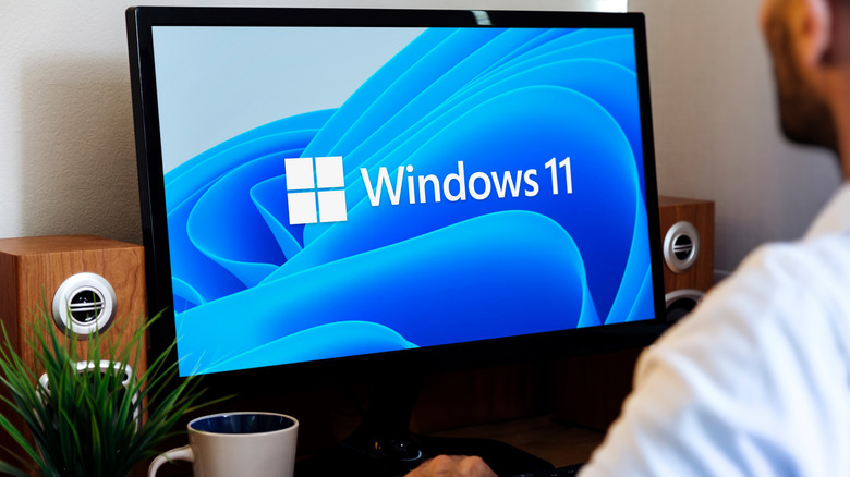 A PC monitor with a Windows 11 logo on it