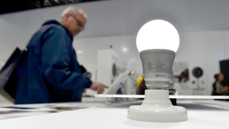 Man standing near test demo of smart lightbulb