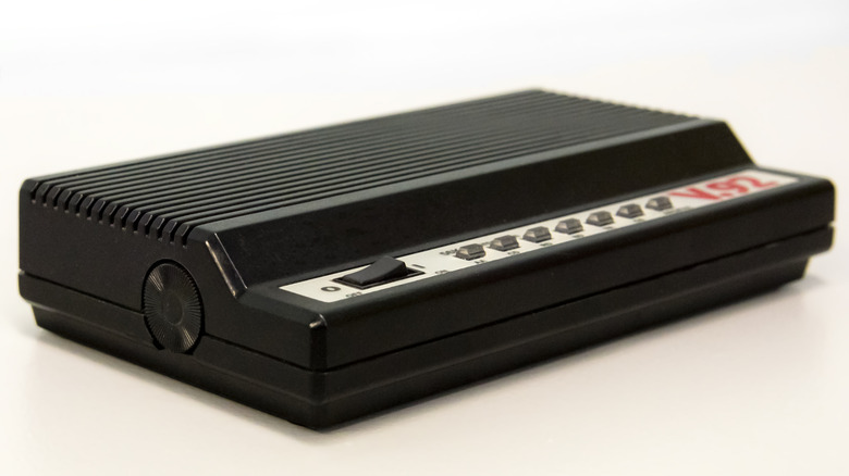 An old dial-up modem resting on a blank background.