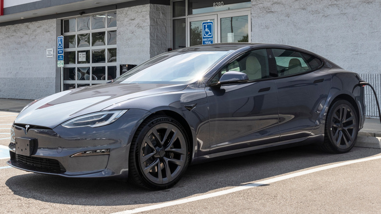 2021 Tesla Model S parked outside a Tesla showroom.