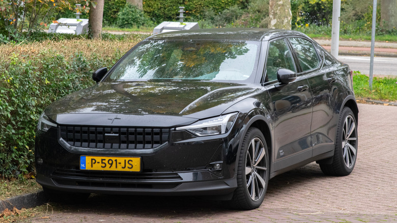 A Polestar 2 2025 parked alongside a curb.