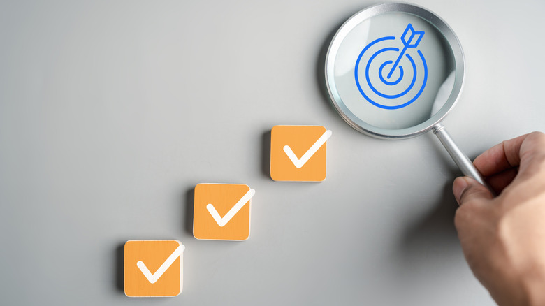 graphic showing check marks and a target icon
