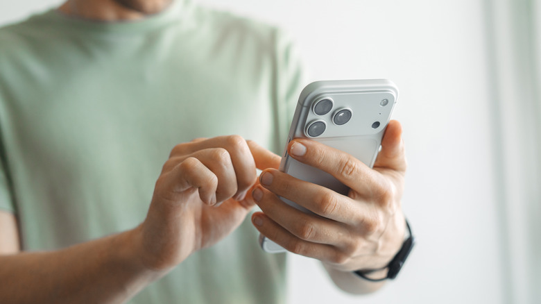 Close-up of a man using iPhone 17 Pro Max indoors