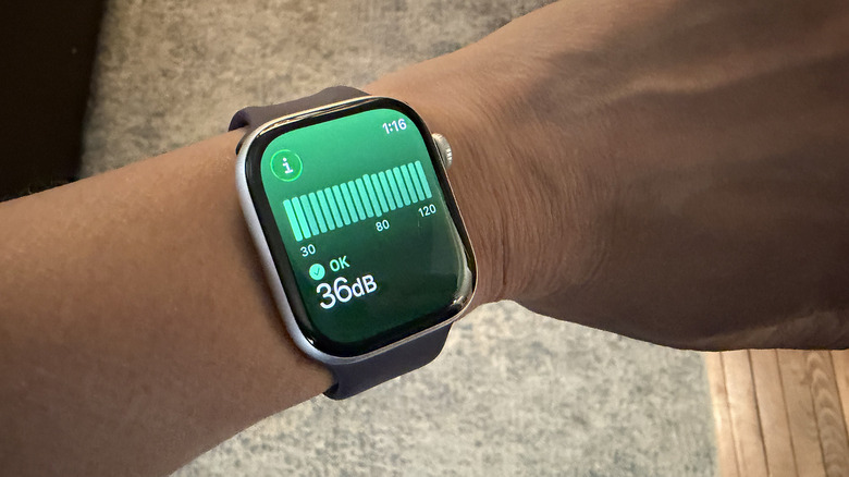 A wrist showing an Apple Watch with a real-time noise monitor.