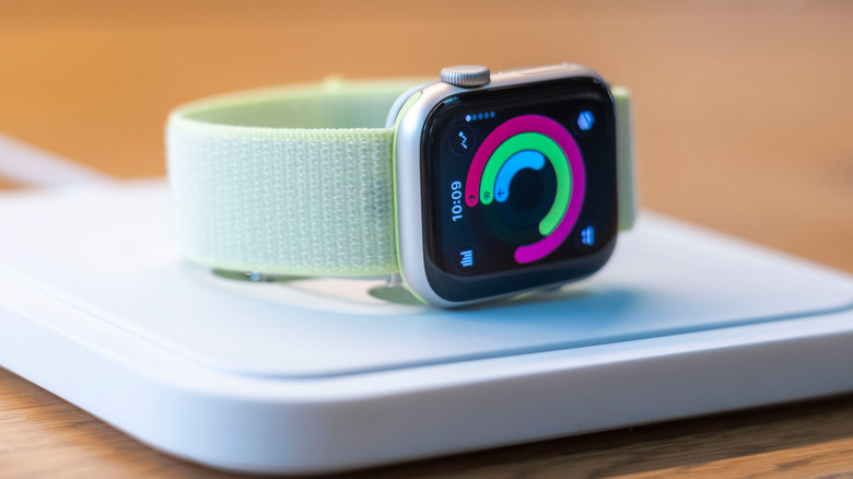 An Apple Watch Series 11 on its side on a white platform.