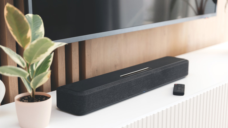 A soundbar beneath a TV.