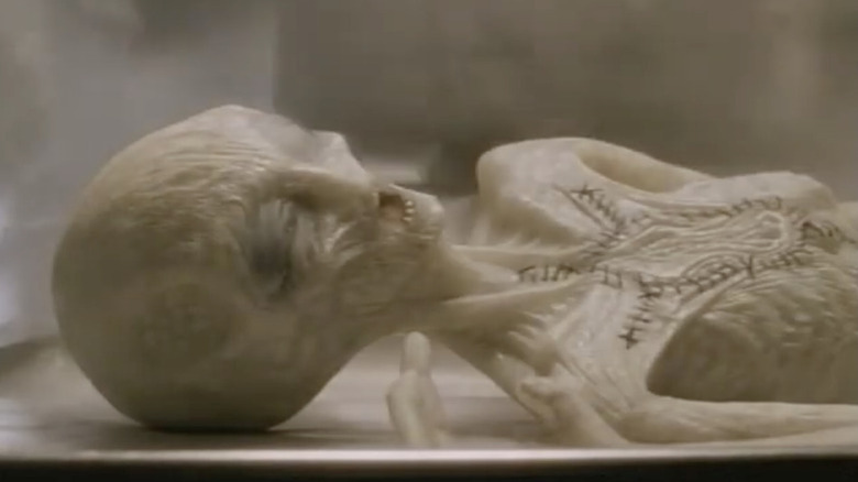 An alien lying on a table on "Dark Skies."