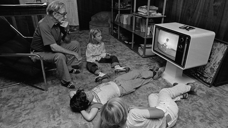 Family watching TV together in the '70s