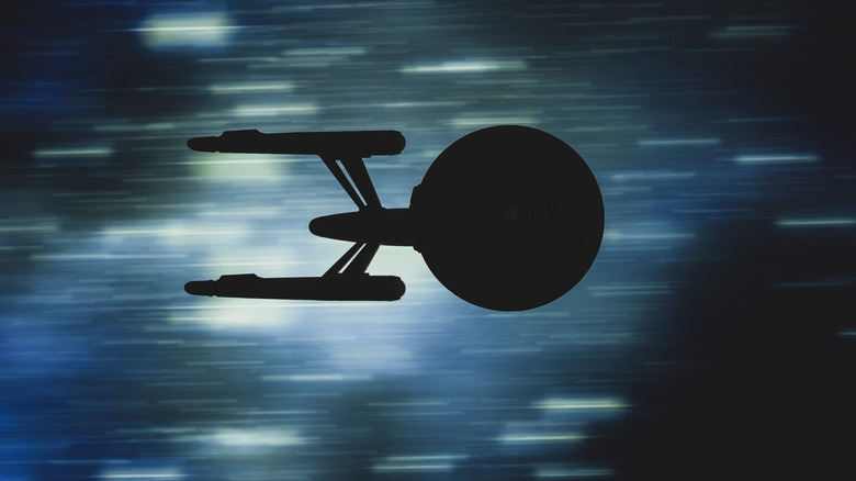 An ornament of the USS Enterprise in a warp.