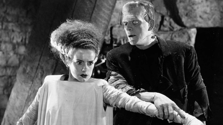 The female monster and Frankenstein's monster standing beside each other in 