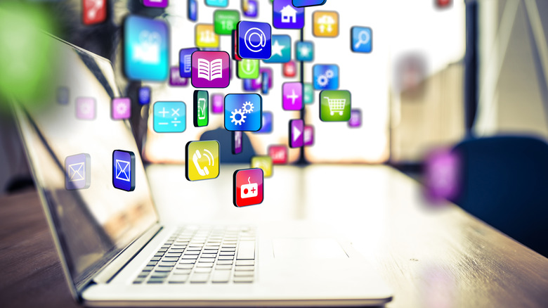 An illustration showing multicoloured applications dropping into a laptop