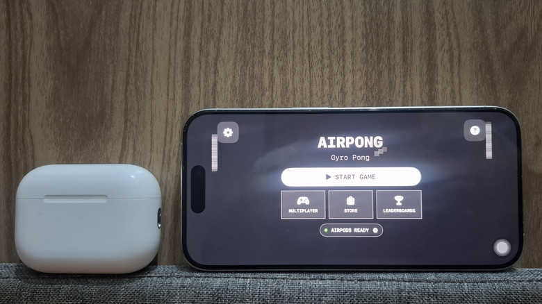 AirPods next to iPhone showing AirPong app