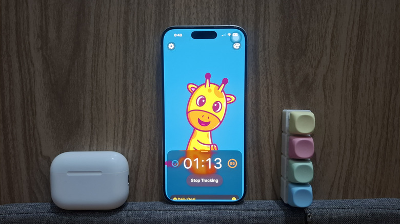 AirPods next to iPhone showing Posture Pal app