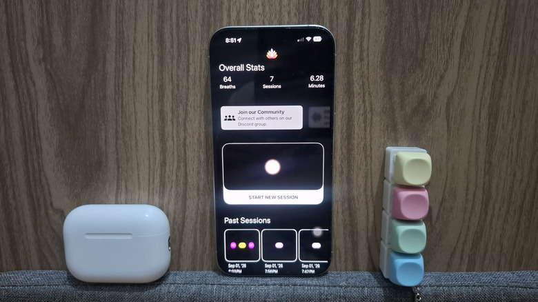 AirPods next to iPhone showing Soul Trace app