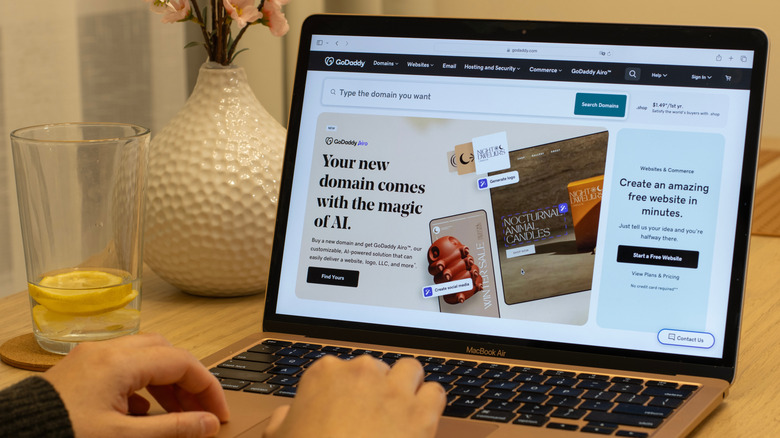 Hands using laptop showing a browser tab