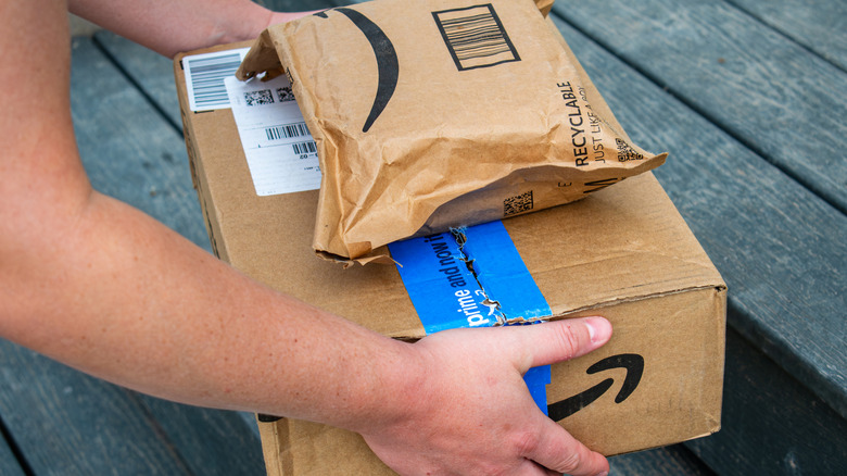 Person carrying Amazon packages