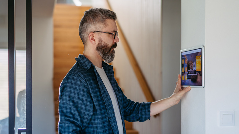 Man adjusting smart home system