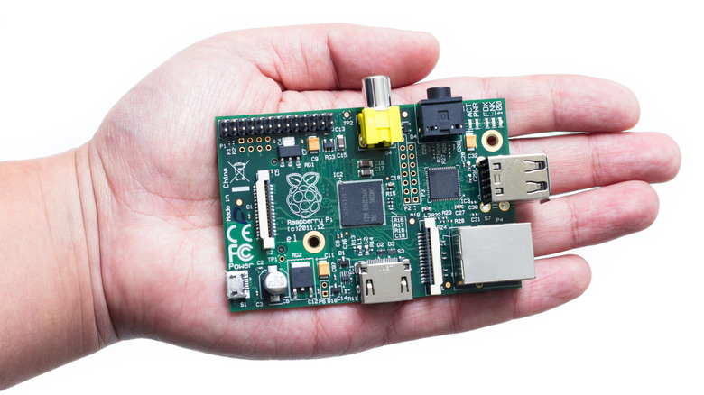 Hand holding a raspberry pi computer